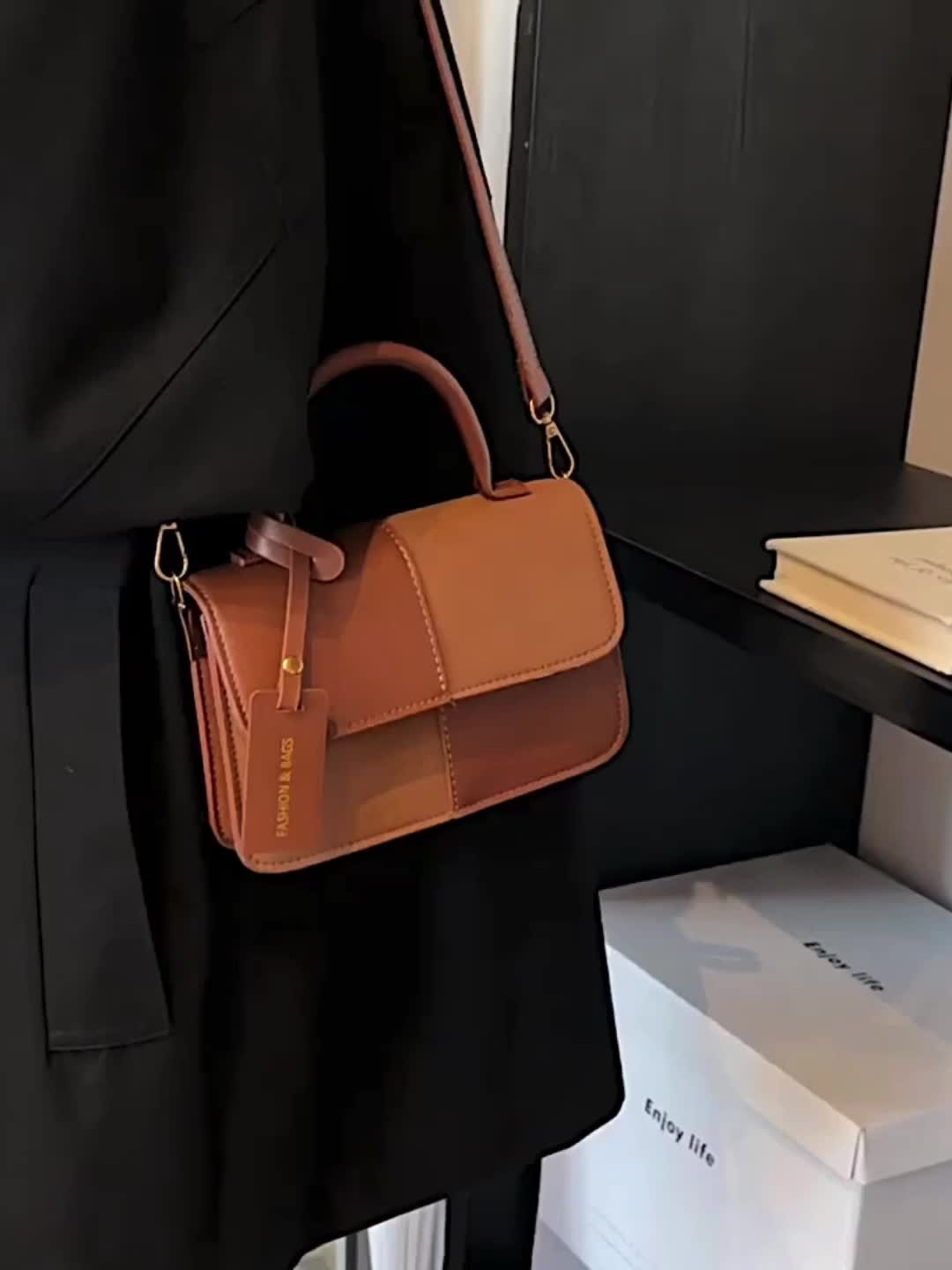 Stylish women's structured top handle bag, a versatile accessory available in multiple elegant colors.