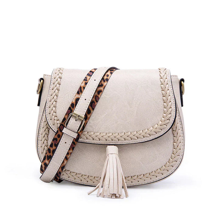 Stylish women's crossbody bag with elegant tassel. This chic handbag is a versatile shoulder bag for daily use.