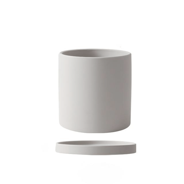 Ceramic flowerpot with built-in drainage system & saucer for healthy indoor plants.