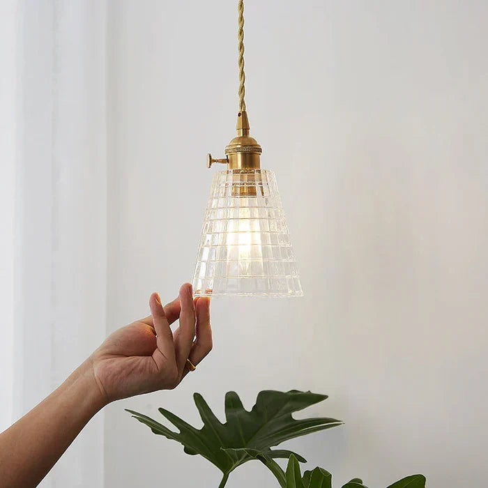 Clear glass modern pendant lamp, an accent for dining areas.
