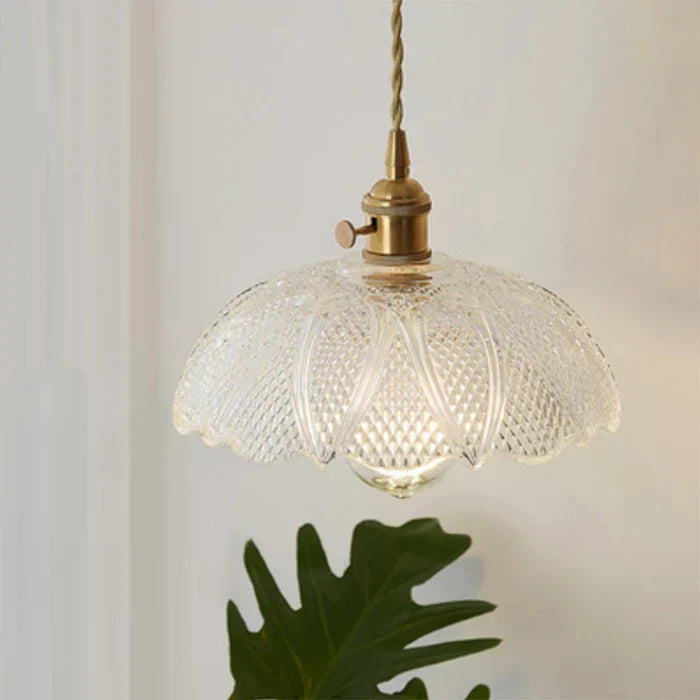 Sleek glass hanging light, perfect for illuminating dining tables.