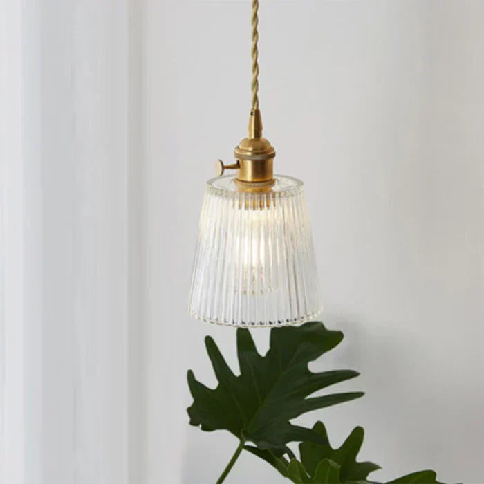 Modern industrial clear glass ceiling light over dining table.