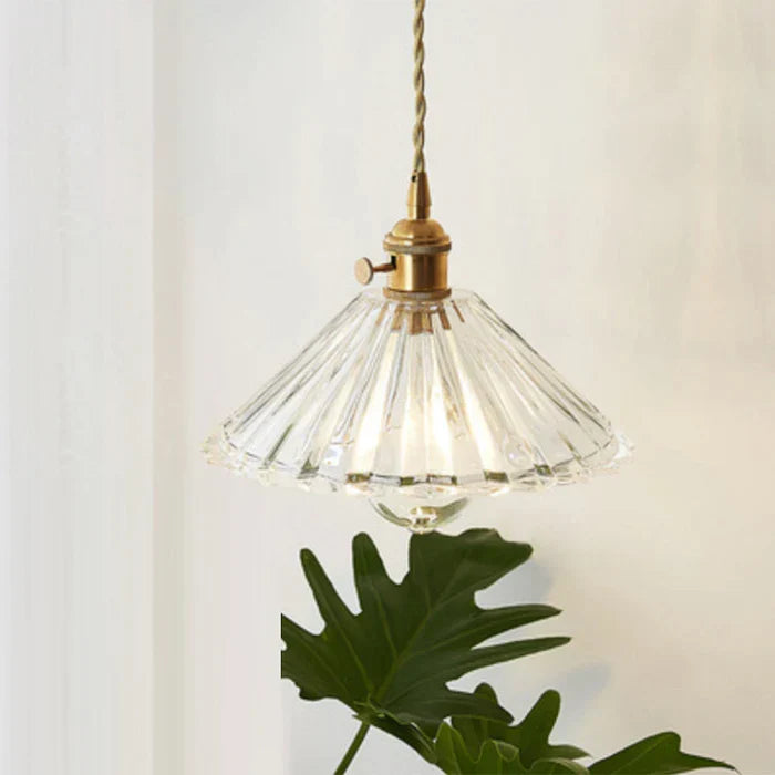 Sleek glass hanging lamp adding elegance to any dining space.