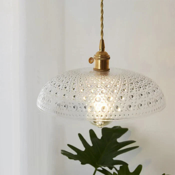Elegant clear glass pendant for a sophisticated dining experience.