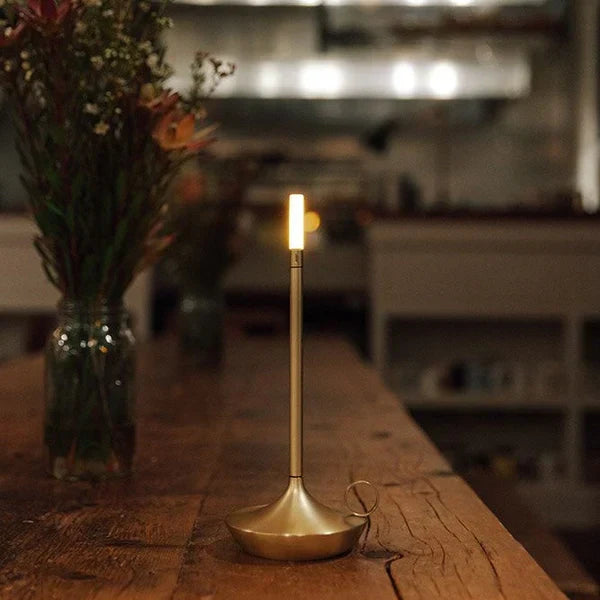 Chic dimmable LED table lamp, rechargeable and cordless for flexible modern home lighting.