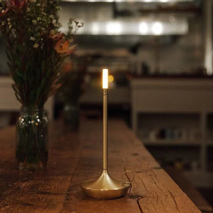 Chic dimmable LED table lamp, rechargeable and cordless for flexible modern home lighting.