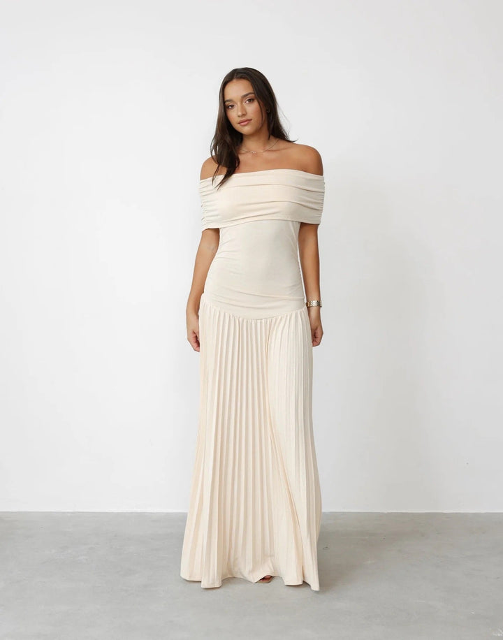 Elegant cream off-shoulder pleated maxi wedding guest dress.