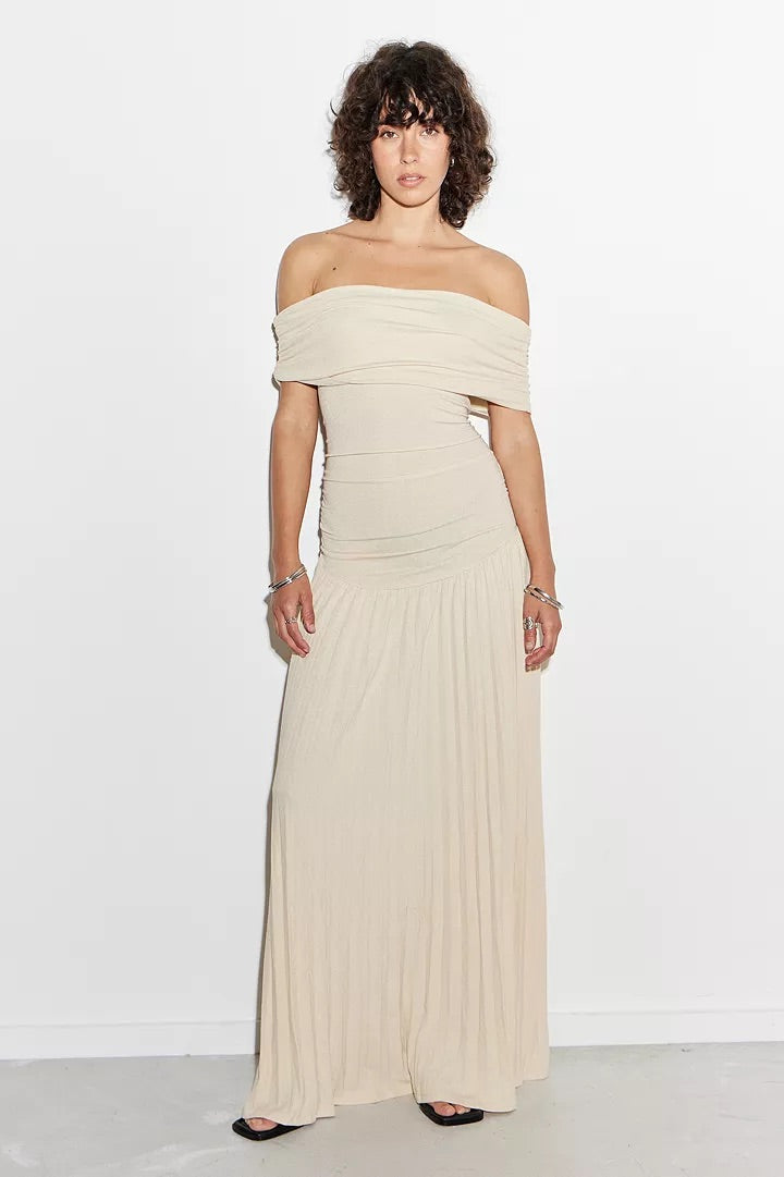 Cream off-shoulder pleated maxi dress with a drop waist, elegant and flowy.