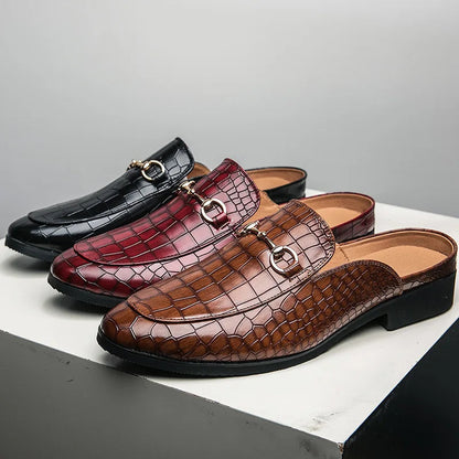 Modern women's croc-embossed slip-on mules, sophisticated fashion footwear featuring a sleek horsebit.