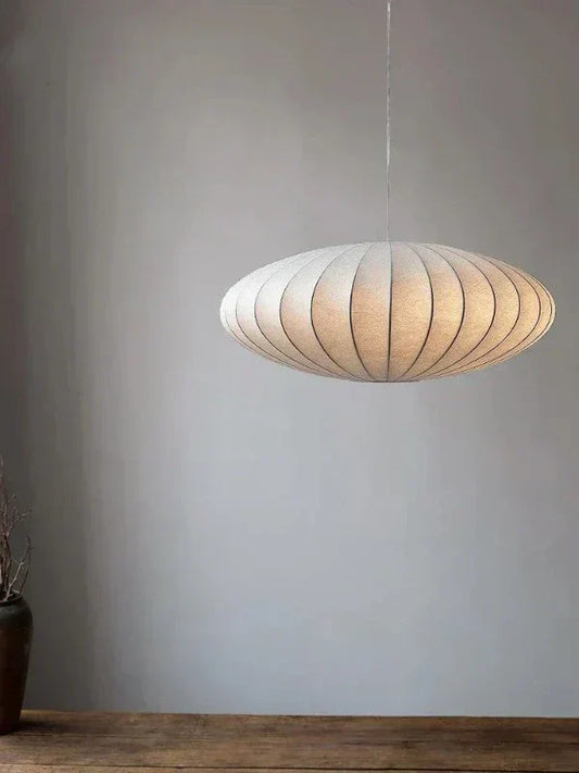 Elegant crystal pendant light with a delicate silk shade for luxury home decor.