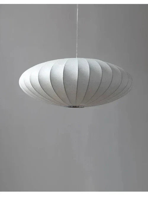 Modern chandelier with intricate crystal details & a sophisticated, soft silk shade.