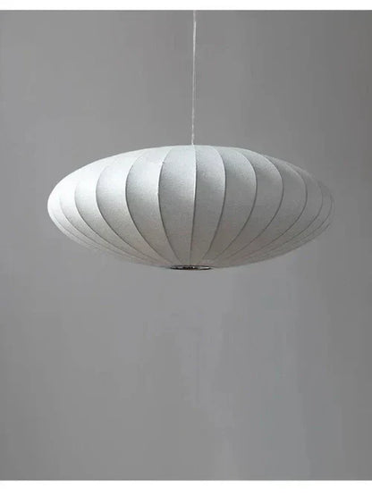 Modern chandelier with intricate crystal details & a sophisticated, soft silk shade.