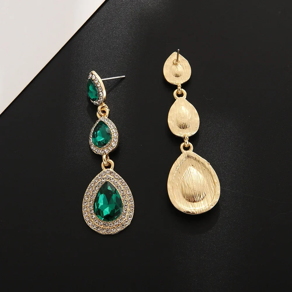 Close-up: Sparkling emerald cascade drop earrings, elegant green dangle jewelry. Ideal gift for her.