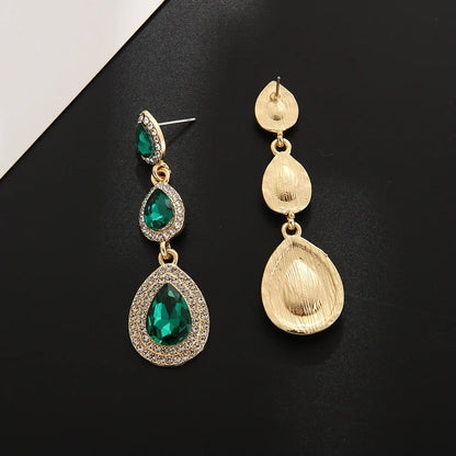 Close-up: Sparkling emerald cascade drop earrings, elegant green dangle jewelry. Ideal gift for her.