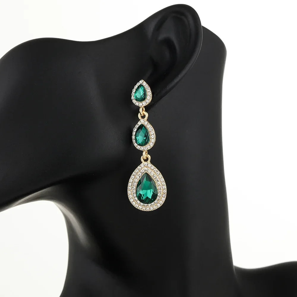 Graceful emerald cascade dangle earrings for women, vibrant green elegant statement jewelry.