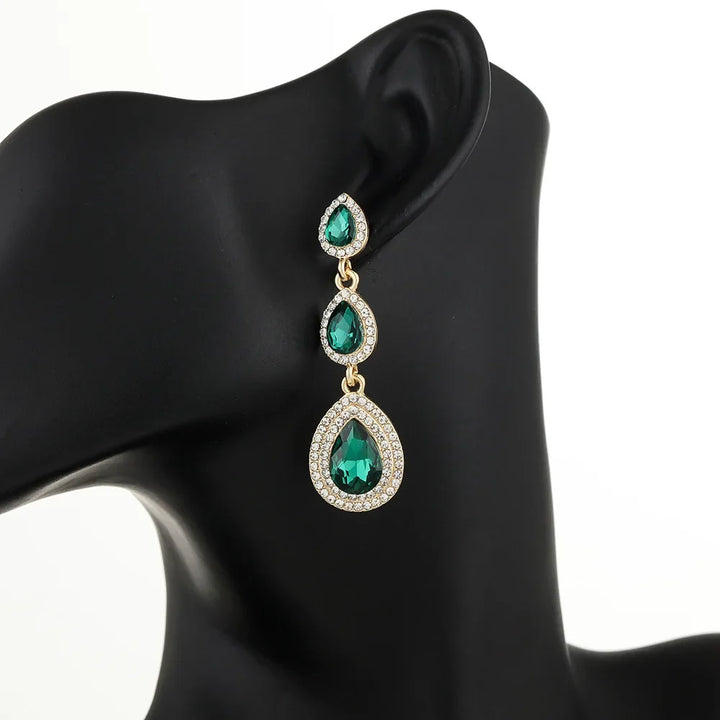 Graceful emerald cascade dangle earrings for women, vibrant green elegant statement jewelry.