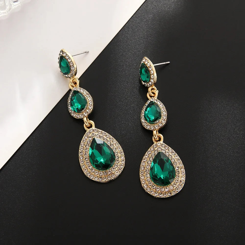 Durable stainless steel emerald drop earrings, elegant green cascade dangle style for women.