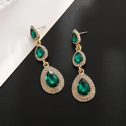 Durable stainless steel emerald drop earrings, elegant green cascade dangle style for women.
