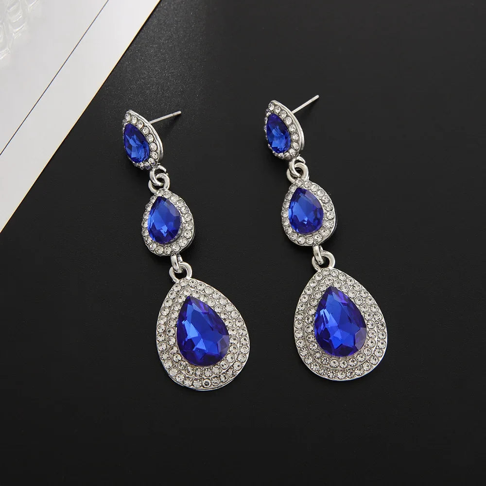 Women's stunning emerald cascade drop earrings, a vibrant green elegant accessory for any occasion.