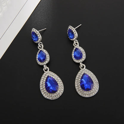 Women's stunning emerald cascade drop earrings, a vibrant green elegant accessory for any occasion.