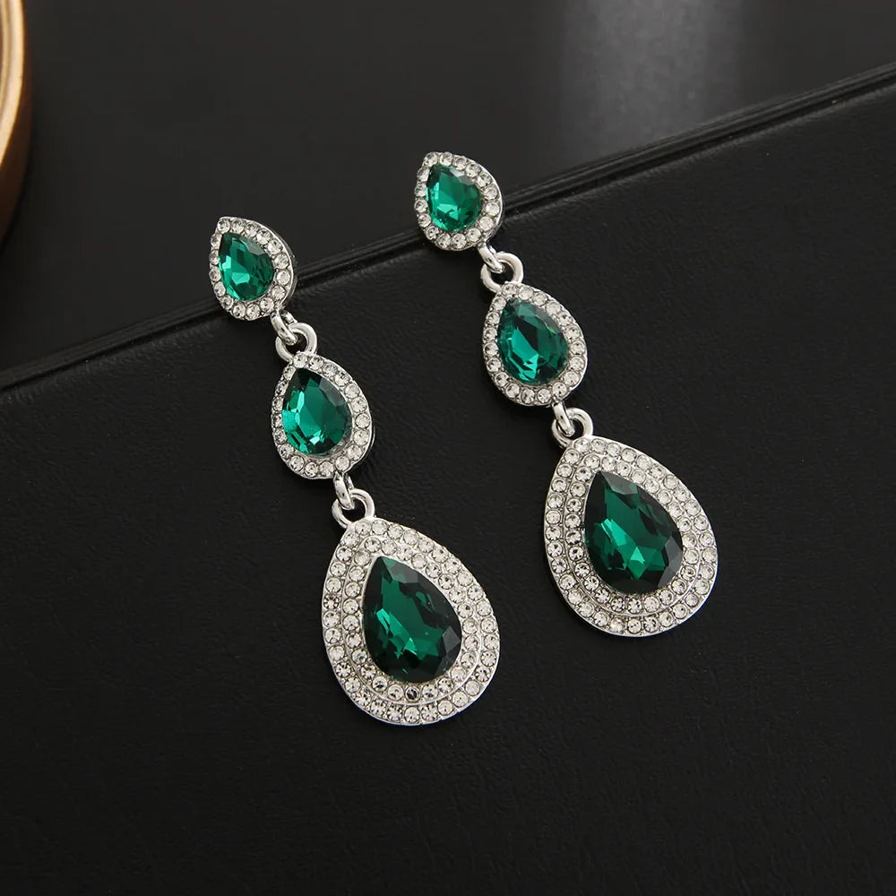 Flowing emerald green cascade drop earrings, elegant stainless steel dangle jewelry for women.