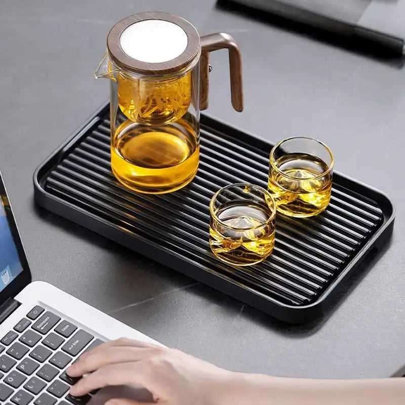 Modern glass teapot with advanced infuser & water separation for elegant loose leaf tea brewing.