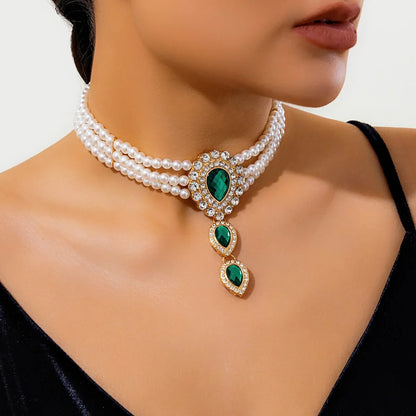 Elegant women's gold necklace & bracelet set, a fashion accessory with shimmering green & white gemstones.