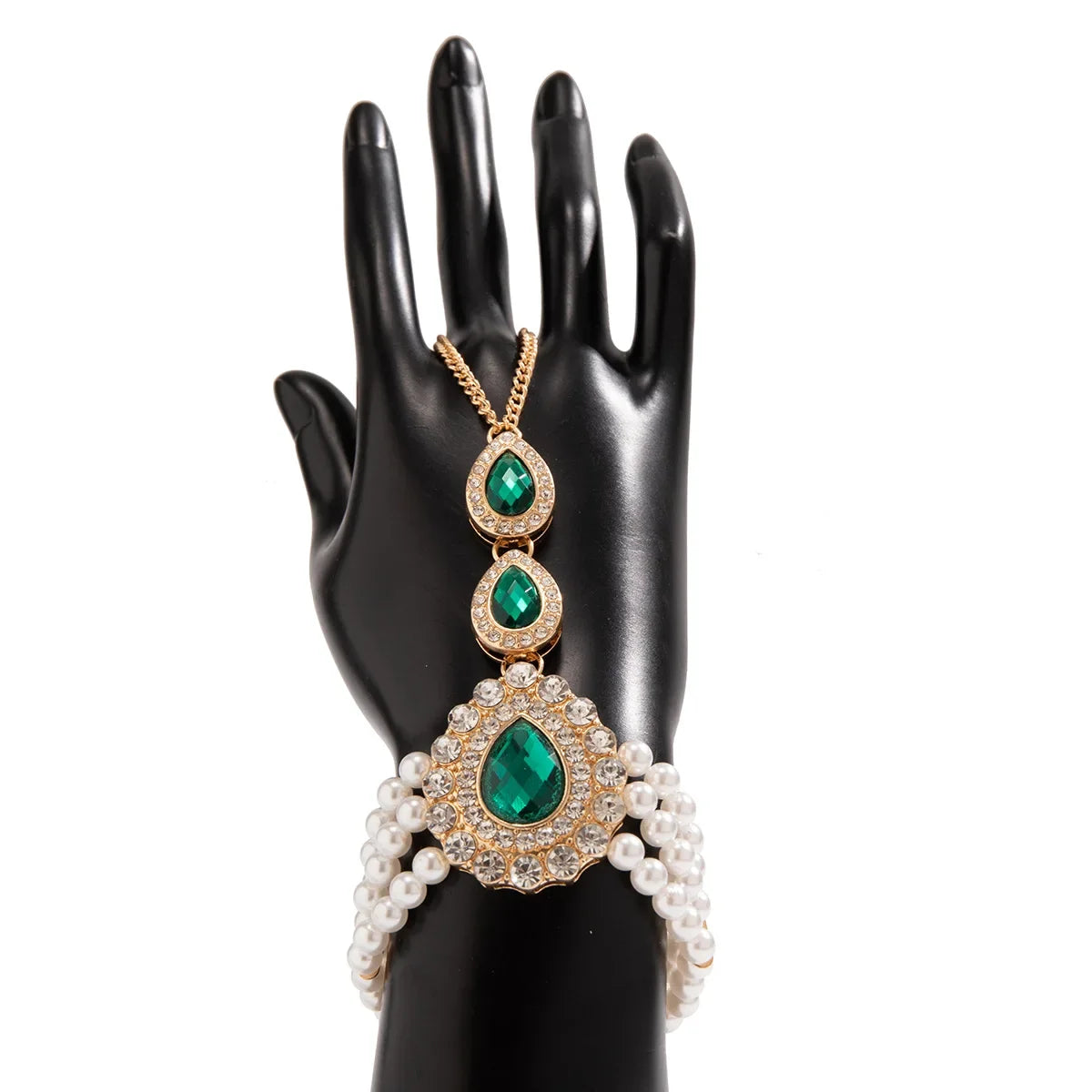 Beautiful women's gold jewelry set, includes an elegant necklace & bracelet adorned with green & white gemstones.