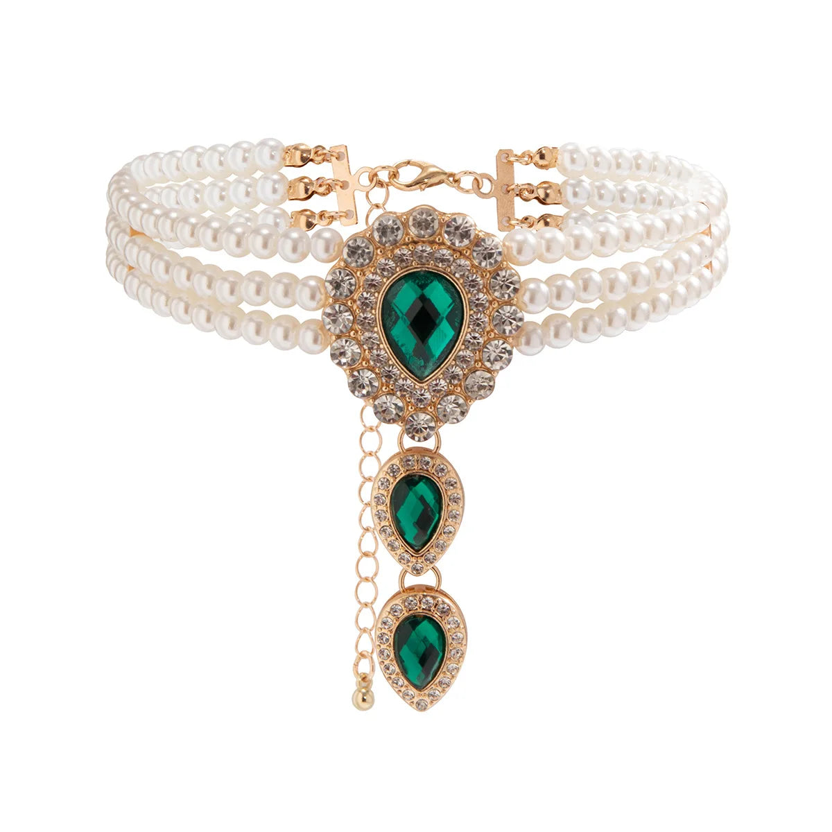 Gold fashion jewelry set for women, featuring a necklace & bracelet with sparkling green & white accent stones.