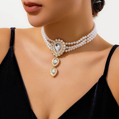 Stunning women's gold jewelry set, necklace & bracelet featuring green and white stones. Elegant fashion accessory.