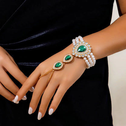 Complete women's gold jewelry set: elegant necklace, matching bracelet, with lustrous green & white gemstones.