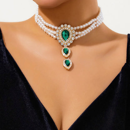 Chic women's gold jewelry set with a stunning necklace & bracelet, featuring elegant green and white stones.