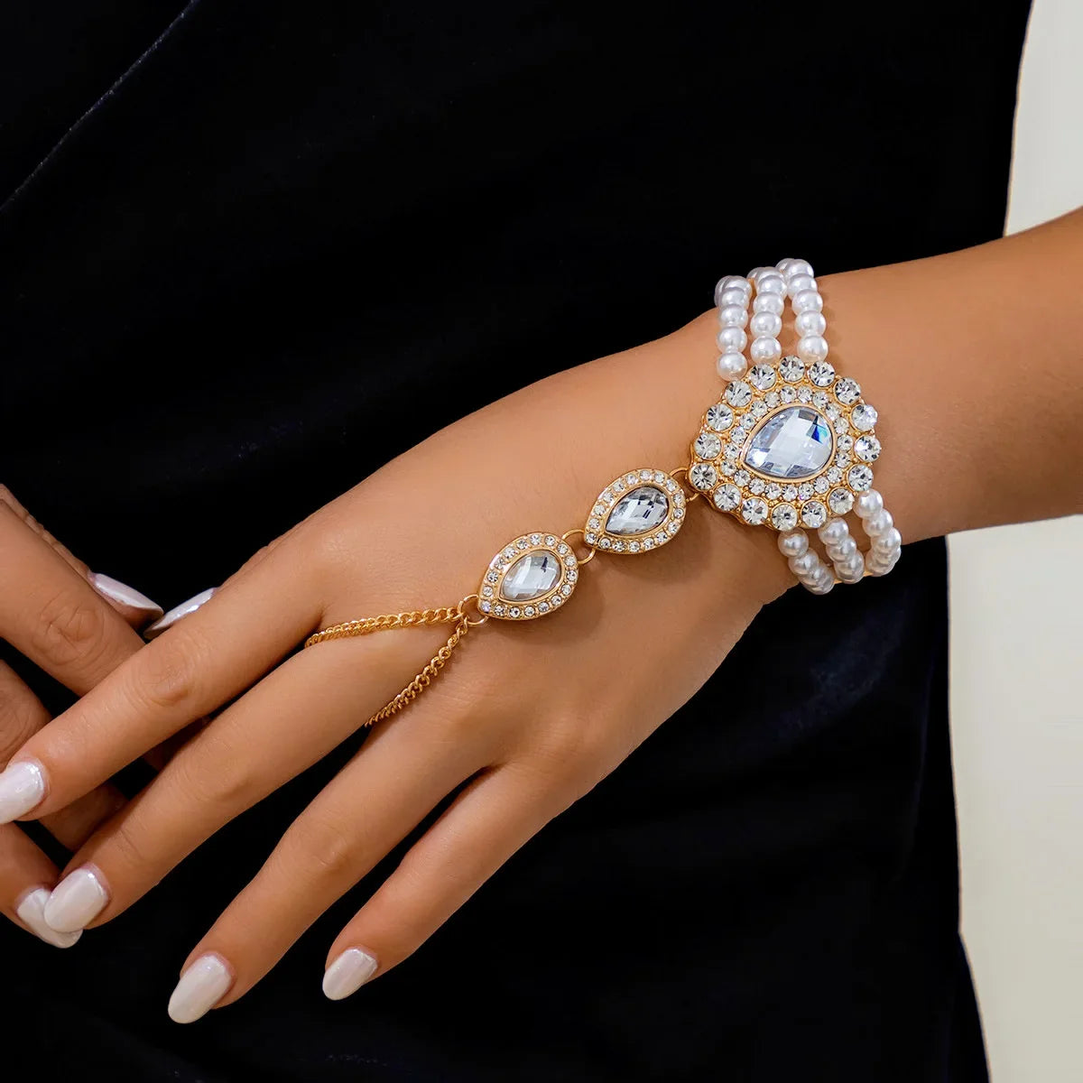 Luxury women's gold jewelry set. Includes an elegant necklace & bracelet, featuring beautiful green & white gemstones.
