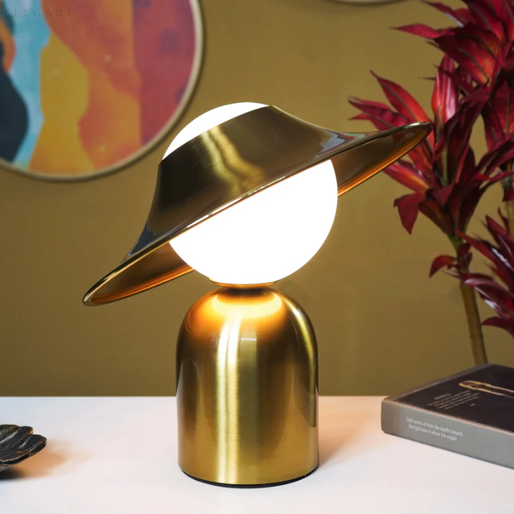 Stylish accent table lamp in polished gold metal, enhancing modern interiors with a touch of elegance and warmth.