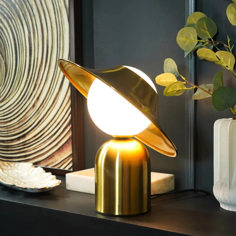 Contemporary gold metal table lamp with a minimalist silhouette, a versatile lighting solution for chic bedroom or lounge areas.