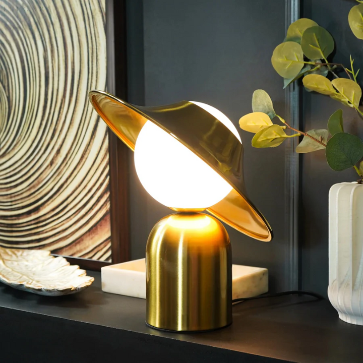 Contemporary gold metal table lamp with a minimalist silhouette, a versatile lighting solution for chic bedroom or lounge areas.