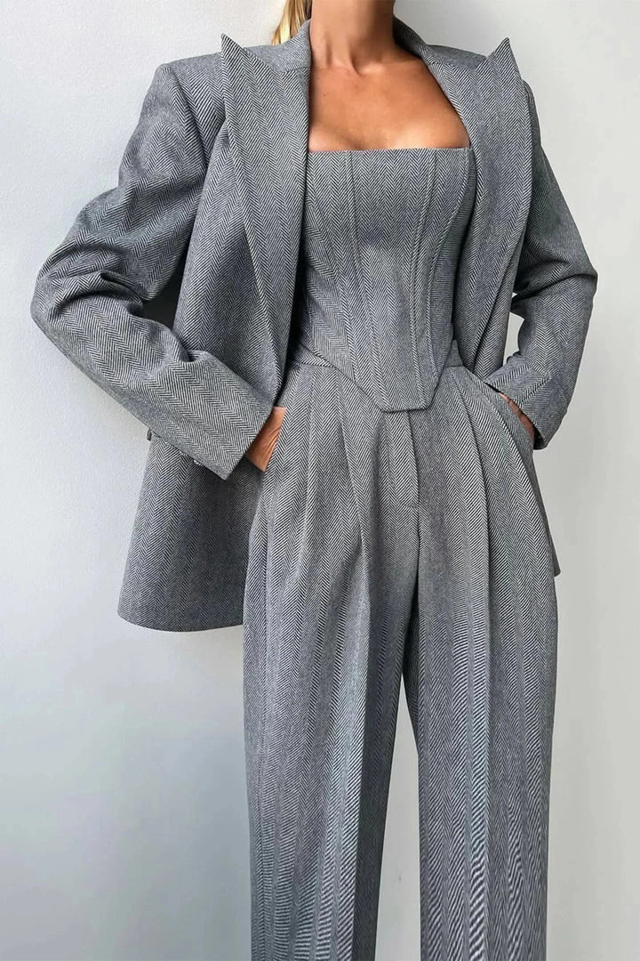 Elegant gray three-piece women's power suit with corset bustier, wide-leg pants & oversized blazer.