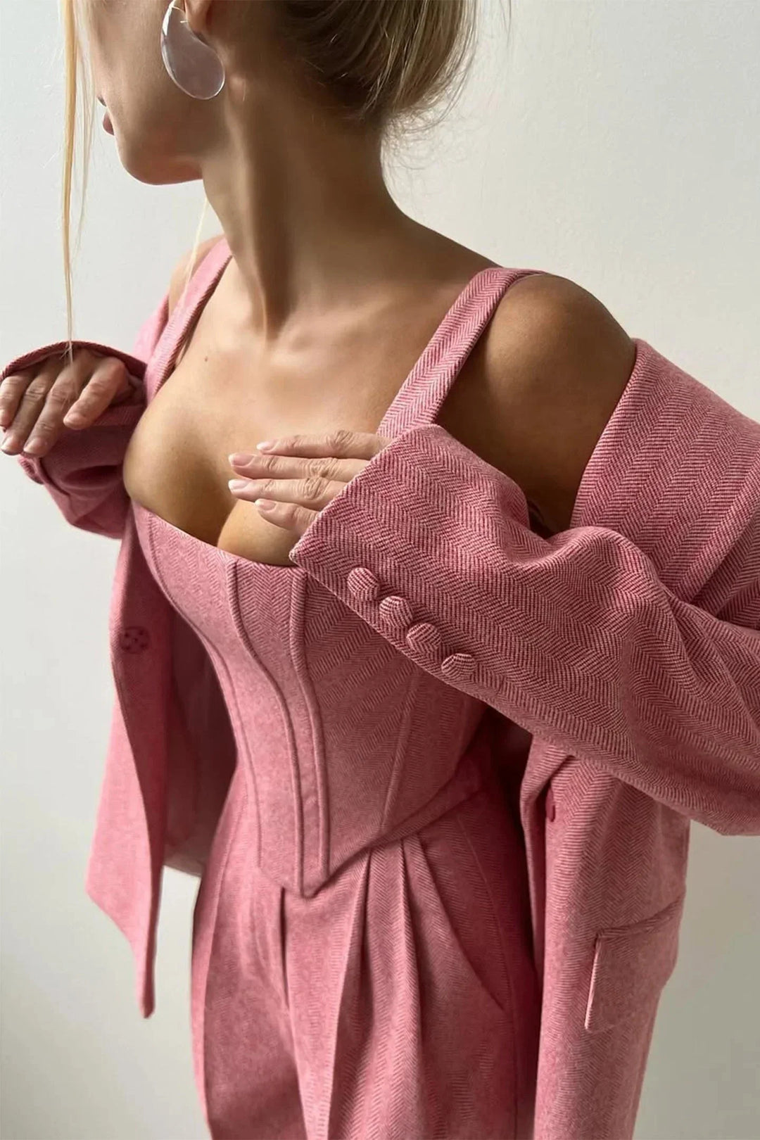 Versatile pink women's three-piece set: bustier, wide-leg pants & blazer, perfect for business chic.