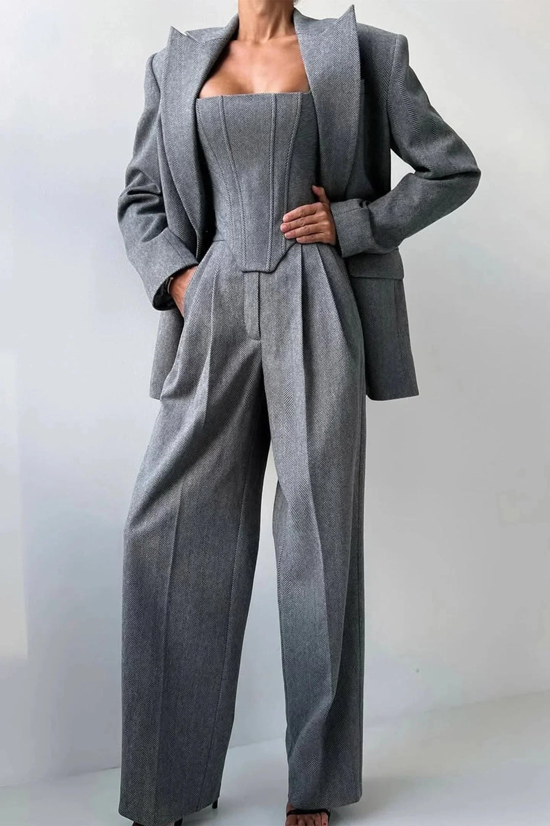 Sophisticated pink women's co-ord set featuring bustier top, wide-leg trousers & matching blazer.