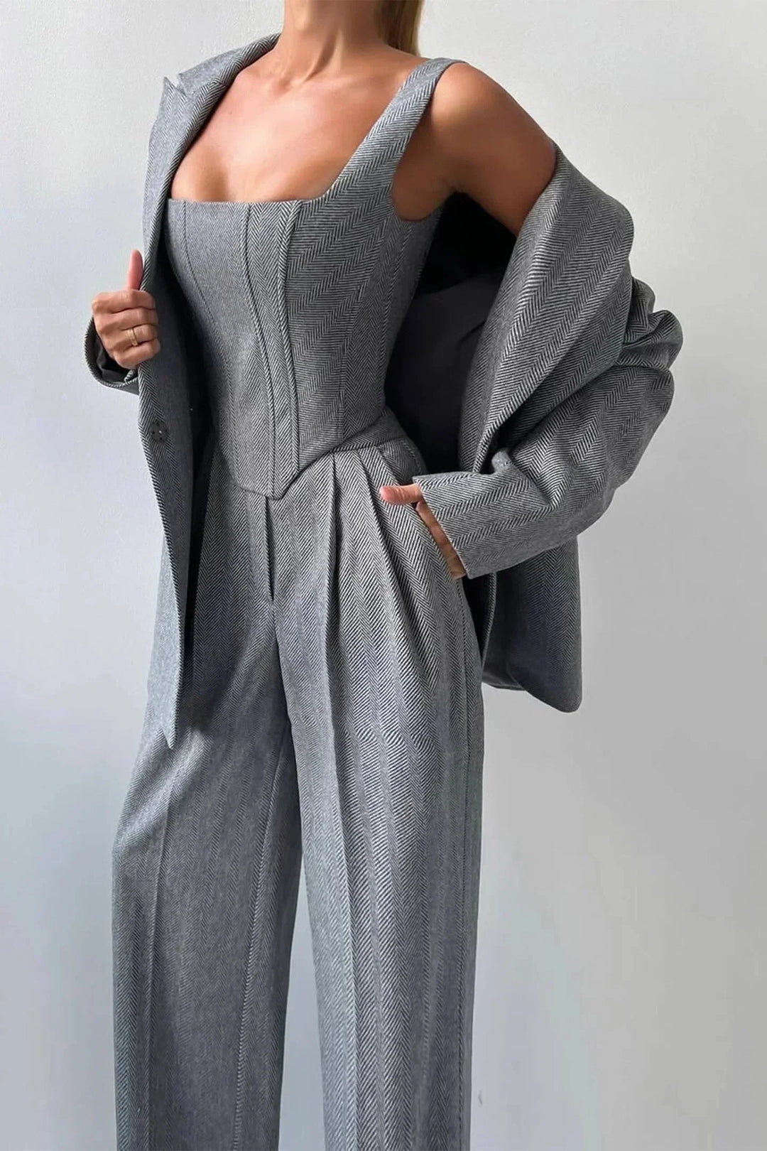 Women's gray power dressing three-piece set: corset, wide-leg pants, and oversized blazer.