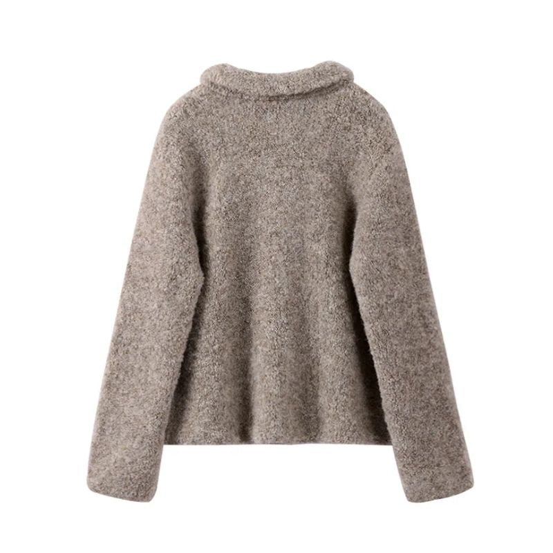 Close-up of a women's vintage gray cardigan featuring unique floral buttons and elegant knit detail.