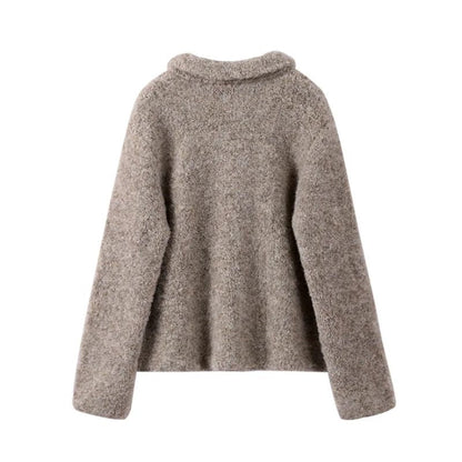 Close-up of a women's vintage gray cardigan featuring unique floral buttons and elegant knit detail.