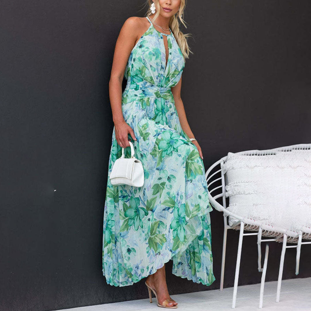 Sleeveless pleated floral maxi dress with a halter neck and twist waist, ideal for elegant occasions.