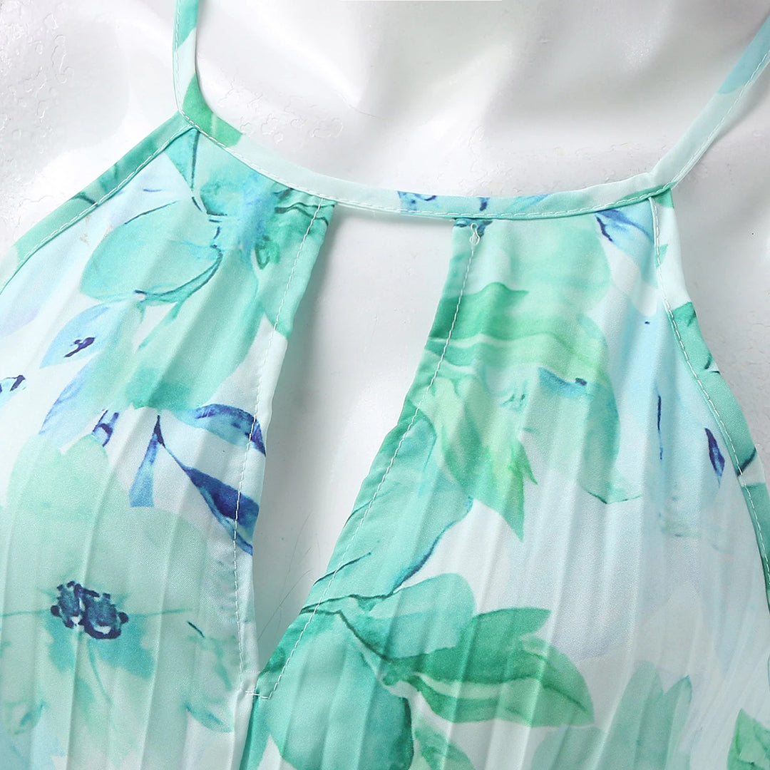 Sophisticated halter neck pleated maxi dress in a floral print, stunning wedding guest attire.