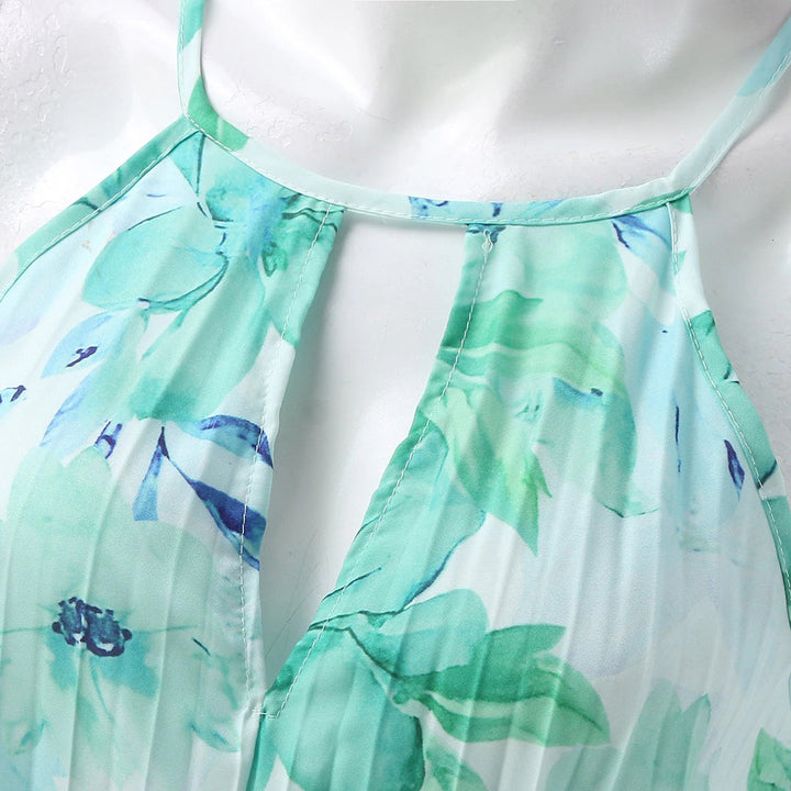 Sophisticated halter neck pleated maxi dress in a floral print, stunning wedding guest attire.
