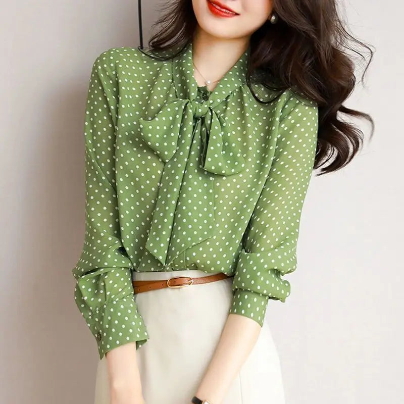Sophisticated black women's long sleeve shirt featuring an elegant bow-accent and shawl collar.