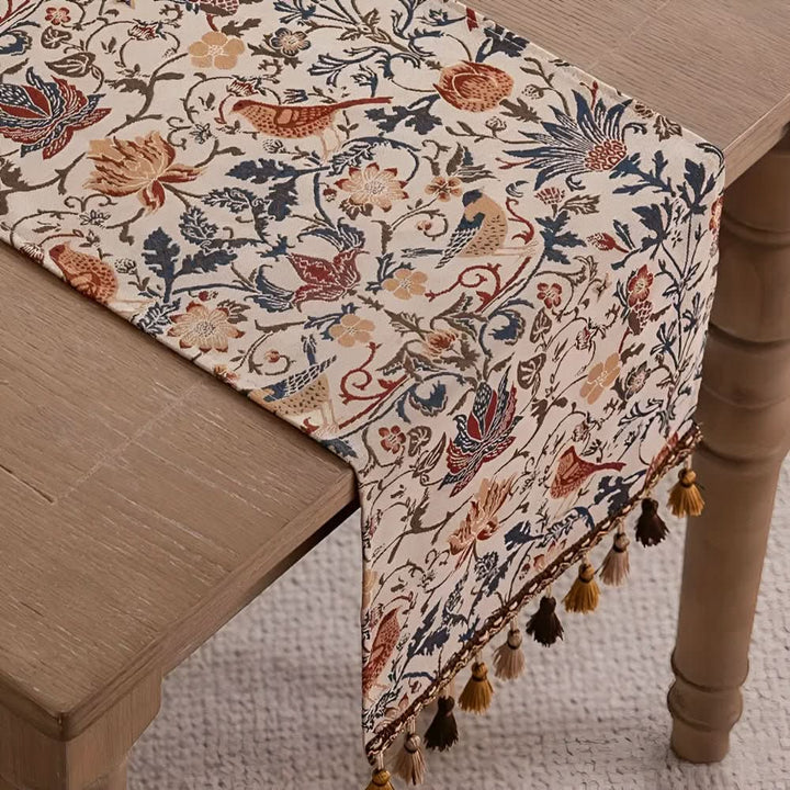 Fringed microfiber table runner, vintage elegance, with a detailed floral bird design.