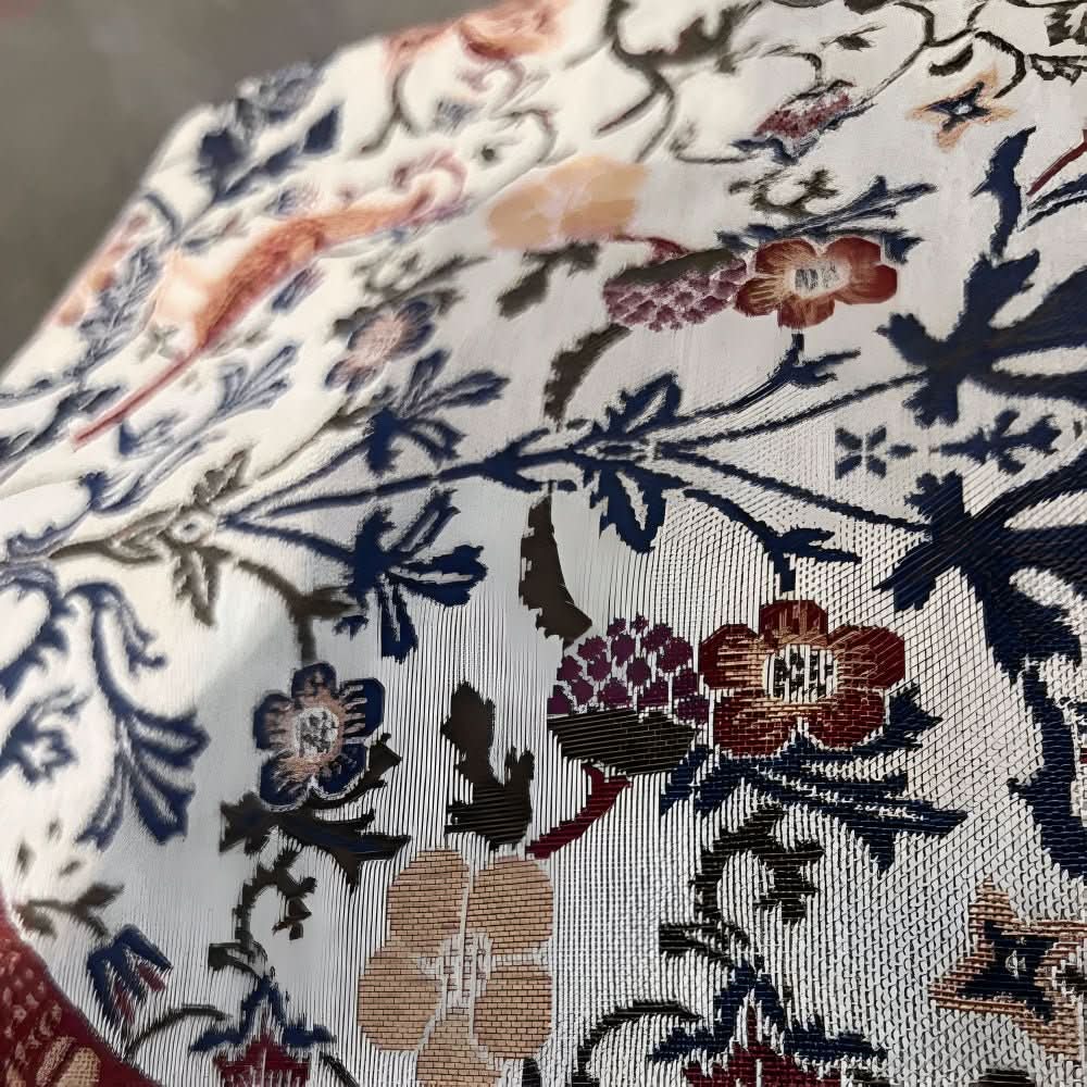 Floral bird jacquard table runner, fringed, adding vintage charm to any dining decor.