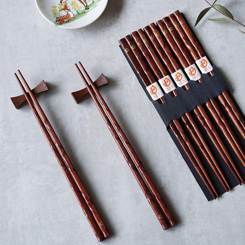 Elegant Japanese wooden chopsticks set with golden cherry blossom design. Perfect for dining & gifting.