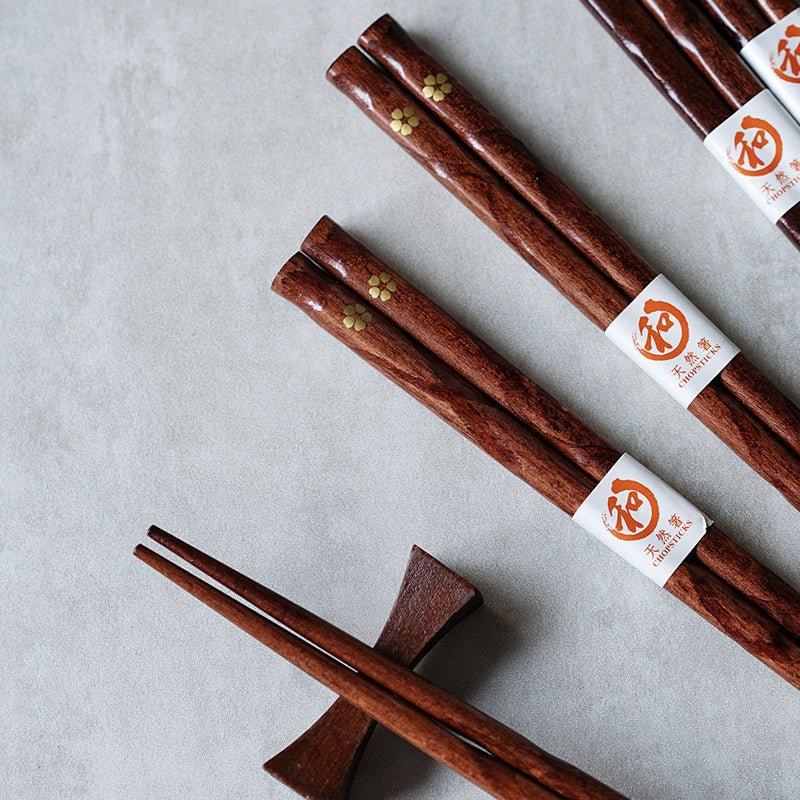 Set of 5 pairs of elegant wooden chopsticks featuring a beautiful golden cherry blossom design, ideal tableware.